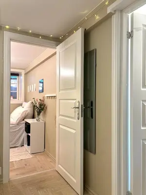 a room with a door leading to a bedroom at Apartment behind Bryggen in Bergen in Bergen