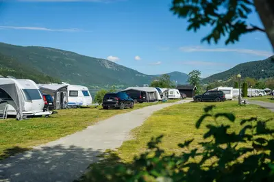 a group of tents and cars parked in a field at Pluscamp Mageli in Bjørge
