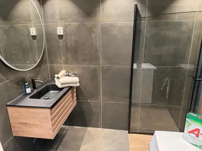a bathroom with a sink and a shower at New apartment by the fjord in Stadlandet