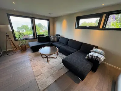 a living room with a couch and a table at New apartment by the fjord in Stadlandet