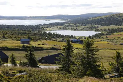 a view of a farm and a lake at Pellestova Apartments in Hafjell