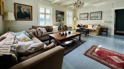 a living room with couches and a table at Kramsjø Gjestgiveri in Herand