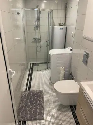 a small bathroom with a shower and a toilet at Comfortable apartment in Ålesund in Ålesund