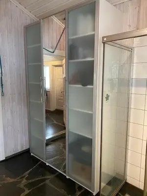 a glass door in a room with a hallway at Stort hus med tømmervegger og fjordutsikt in Stranda