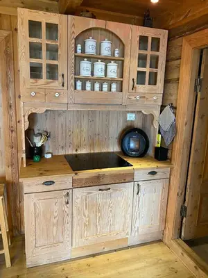a kitchen with a sink in a wooden cabin at Stort hus med tømmervegger og fjordutsikt in Stranda