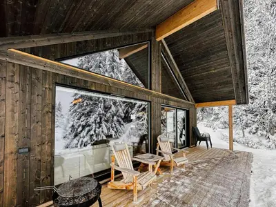 a cabin in the snow with a table and chairs at Modern Cabin With Mountain View By Syningtoppen in Torpo