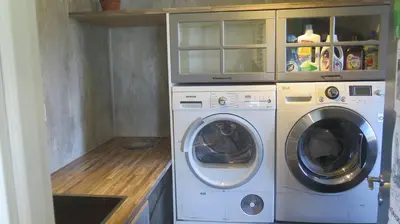 a laundry room with a washer and a dryer at Sara's Fjord View House in Stadlandet