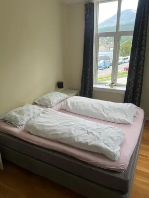 two beds in a bedroom with a window at Apartment in Stryn in Stryn