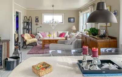 a living room with a couch and a table at 3 Bedroom Cozy Apartment In Myklebost in Myklebost