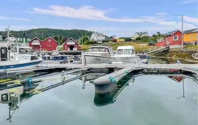 a bunch of boats are docked at a dock at 3 Bedroom Cozy Apartment In Myklebost in Myklebost