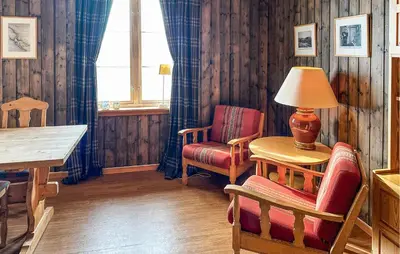 a room with a table and two chairs and a lamp at Awesome Apartment In Rauland in Rauland