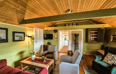 a living room filled with furniture and a wooden ceiling at Nice Home In Valen With House Sea View in Valen