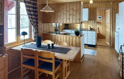 a kitchen with wooden cabinets and a wooden table and chairs at Nice Apartment In Rauland With Wifi in Rauland