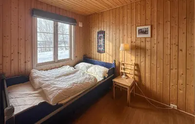 a bed in a wooden room with a window at Nice Apartment In Rauland With Wifi in Rauland