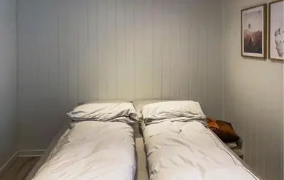 two beds sitting next to each other in a room at 1 Bedroom Gorgeous Apartment In Kvisvik in Kvisvik