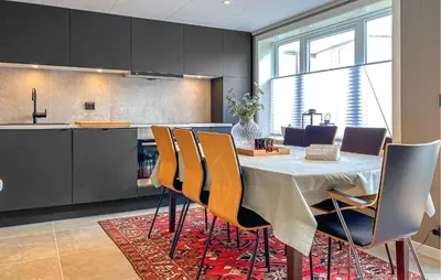 a dining room with a table and chairs in a kitchen at Lovely Apartment In Myklebost With Wifi in Myklebost