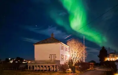 an old building with the aurora in the sky at Lovely Apartment In Myklebost With Wifi in Myklebost