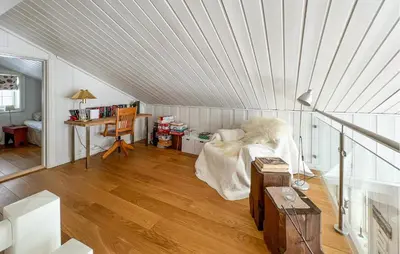 a attic room with a bed and a desk at Lovely Home In Aurdal With Sauna in Aurdal