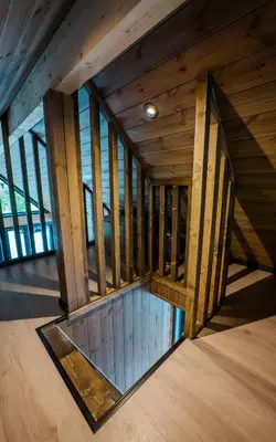 an empty room with wooden walls and wood floors at Flåm Minisuite in Aurland