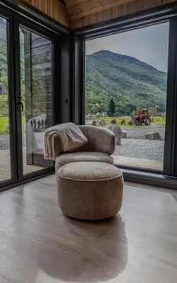 a chair sitting in a room with a large window at Flåm Minisuite in Aurland