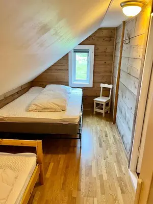a bedroom with a bed and a chair in a room at Hylen in Kvilldal