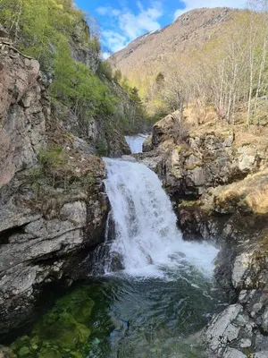 a waterfall on the side of a mountain at Over the Fjord in Leikanger