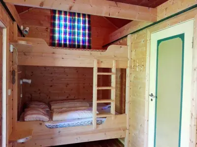 a wooden cabin with two bunk beds in it at Vårsetra in Bø