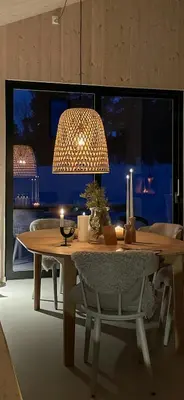 a dining room with a table and a light fixture at Cozy Cabin At The Gateway To Jotunheimen in Vaga