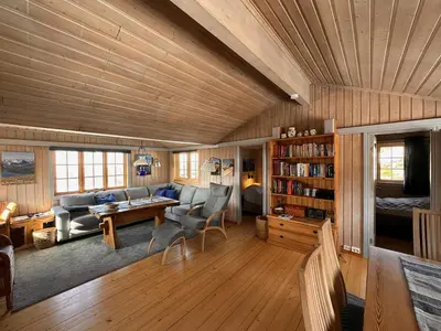 a living room with a couch and a table at A Peaceful Mountain Retreat in Beitostøl
