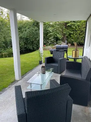 a patio with chairs and a table and a grill at Rancho Apartment with King size bed in Sula