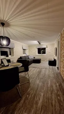 a large living room with a bed and a couch at Rancho Apartment with King size bed in Sula