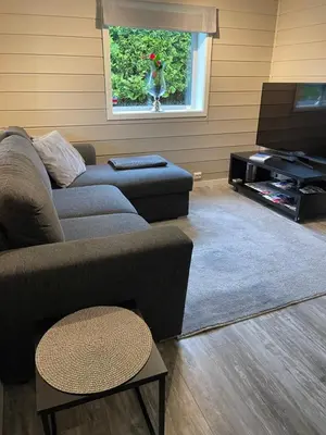 a living room with a couch and a tv at Rancho Apartment with King size bed in Sula