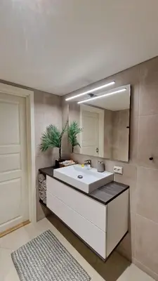 a bathroom with a sink and a mirror at Rancho Apartment with King size bed in Sula