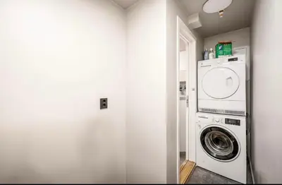 a white laundry room with a washer and dryer at Townhouse - 700 meters from Bryggen in Bergen