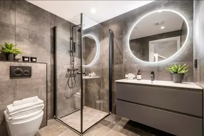 a bathroom with a shower and a sink and a mirror at Townhouse - 700 meters from Bryggen in Bergen