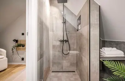 a shower with a glass door in a bathroom at Townhouse - 700 meters from Bryggen in Bergen