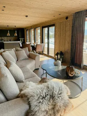 a living room with a couch and a table at Modern Cabin With Panoramic Views In Stryn in Stryn