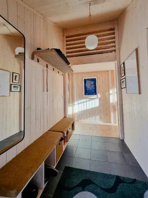 a large room with a long counter and a television at Bright Cabin In Eggedals Beautiful Mountains in Eggedal