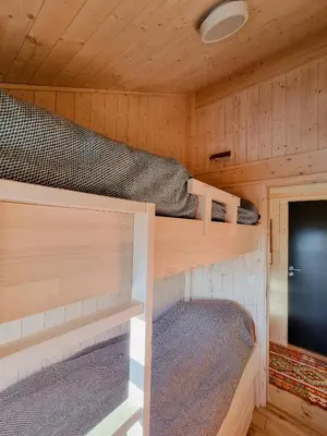 a bedroom with two bunk beds in a cabin at Bright Cabin In Eggedals Beautiful Mountains in Eggedal