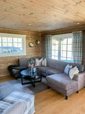 a living room with a couch and a table at Family Cabin At Blefjell in Lampeland