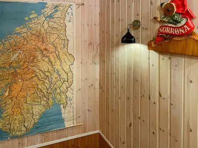 a teddy bear sitting on a shelf next to a map at Mountain Gem With Ski Inout In Rauland in Rauland