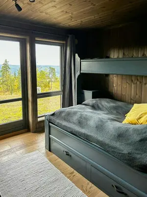 a bedroom with a bunk bed and two windows at Modern Cabin With Panoramic Views At Nesfjellet in Nesbyen