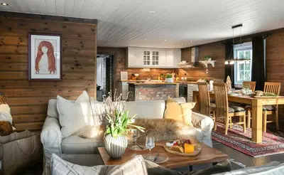 a living room with a couch and a table at Family Cabin With Shelter By Lake Gautetjern in Gol