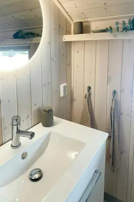 a bathroom with a white sink and a mirror at Cabin With A View And Close To Jotunheimen in Heggenes