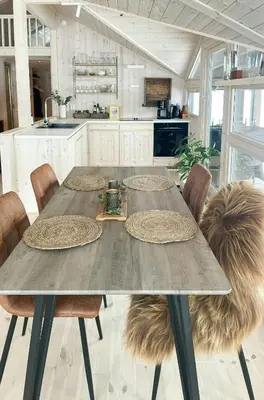 a kitchen with a table and some chairs and a kitchen at Cabin With A View And Close To Jotunheimen in Heggenes
