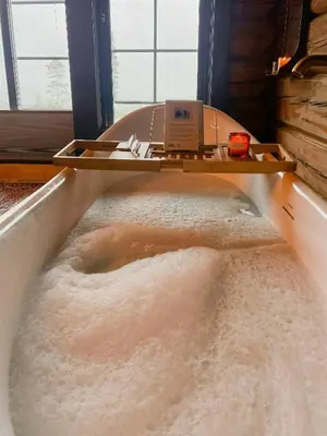 a bath tub filled with lots of sand in a room at Log Cabin With Views Over Turufjell in Flå