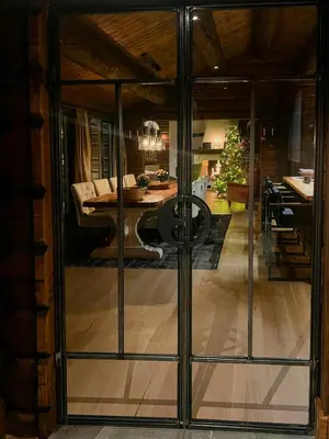 a room with glass doors leading to a dining room at Log Cabin With Views Over Turufjell in Flå