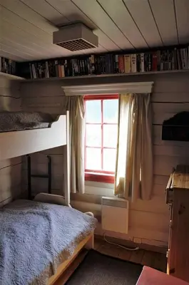 a bedroom with a bunk bed and a window at Traditional Hemsedal family cabin spectacular view in Hemsedal