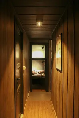 a hallway leading to a bedroom with a bed at Charming Cabin In Vikerfjell in Hønefoss