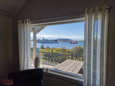 a room with a window with a view of the water at Færøya 49 in Nekkøyane